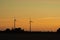 Windmills generating electricity during sunset