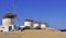 Windmills on a hillside near the sea. Mykonos.