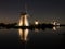 Windmills lit at night