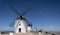 Windmills and old castle in Consuegra, Toledo, Castilla La Mancha, Spain. Several windmills and castle on a hill under a little