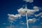 windmills over a blue and cloudy sky