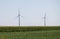 Windmills power plant in rural landscape. Wind turbine farm for electric power production. Windmills for electric power production