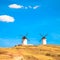 Windmills, rural green fields and blue sky. Consuegra, Spain