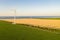 Windmills on the seaside, wind turbine power generators at sunset