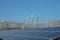 Windmills and solar panels against mountain and blue sky background