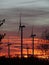 Windmills at sunset over land