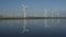 Windmills turbines with water reflection