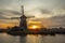 Windmills and water canal on sunset in Kinderdijk, Holland