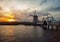 Windmills and water canal on sunset in Kinderdijk, Holland