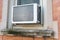 Window Air Conditioning Unit seen from Outside on a Brick Urban Building