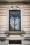 Window of an ancient Italian villa with artistic iron grill.