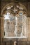 The window of the ancient medieval castle in the Gothic style from which can see the beautiful carved towers of the castle.