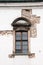 Window with an arched detail above it and exposed brick in Budapest, Hungary