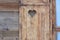 Window blind of a wooden hut with a heart shaped hole