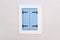 Window with blue shutters. Architectural composition. Closed window.