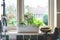 Window box with herb garden and spring bulbs growing in a home kitchen interior