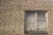 The window is bricked from the inside. Abandoned house. White brick wall with a window.