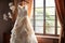 Window charm Wedding dress on a curtain rail, near a window