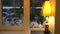 window with Christmas patterns on the glass and a lamp on the windowsill