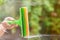 Window cleaner using a squeegee to wash a window. Clean horizontal bar