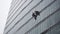 Window cleaners hanging from a high rise building