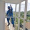 window cleaning worker hanging outside with safety equipment