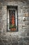 A window decorated with flower pots in a small Bulgarian town.