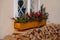 Window decoration for Christmas in the form of plant branches and red berries in a wooden pot on the building window. Folded