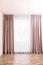 Window with elegant curtains in empty room