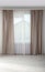 Window with elegant curtains in empty room