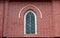 Window frame and red brick of exterior of main church at cathedral of the holy trinity.