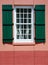 Window and green shutters in european village