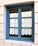 Window with hand made embroidered curtain in Vathi town, Ithaca island, Ionian islands, Greece.