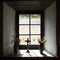 Window in historic watermill with crucifix and vases