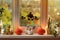 The window of a house decorated for the holiday. Halloween decorations on window: pumpkins, stickers of smiling Jack and scary hou