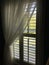 Window with indoor shutters and curtain