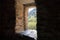 A window  inside a lonely riverbank at the foot of the mountains of the watchtower - Koshki - called the Tower of Love in Svaneti