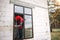 The window installer adjusts the hinges and checks new windows in the cottage under construction. Ordering windows with golden