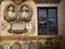 Window with medallions of two busts of statues  to Verona in Italy.