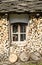 Window of mountain house with stone roof and firewood, Bulgaria