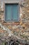 Window of old abandoned and dilapidated stone house in the Tuscan countryside in Italy