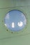 Window in old airplane, aluminum background detail of a military aircraft