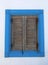 Window of the old Greek Home with Brown Window shutters and Blue Frames