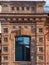 The window of the old mansion 19 century with brown bricks wall