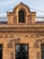 The window of the old mansion 19 century with brown bricks wall