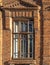 The window of the old mansion 19 century with brown bricks wall