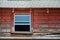 Window of an old weathered red barn