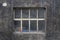 Window out of metal frame and filled with small elements of glass at the basement of an older German building