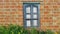 Window and red brick wall in a colorful style. Authentic design