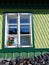 Window of a sculpted and decorated green wood house of Romania.